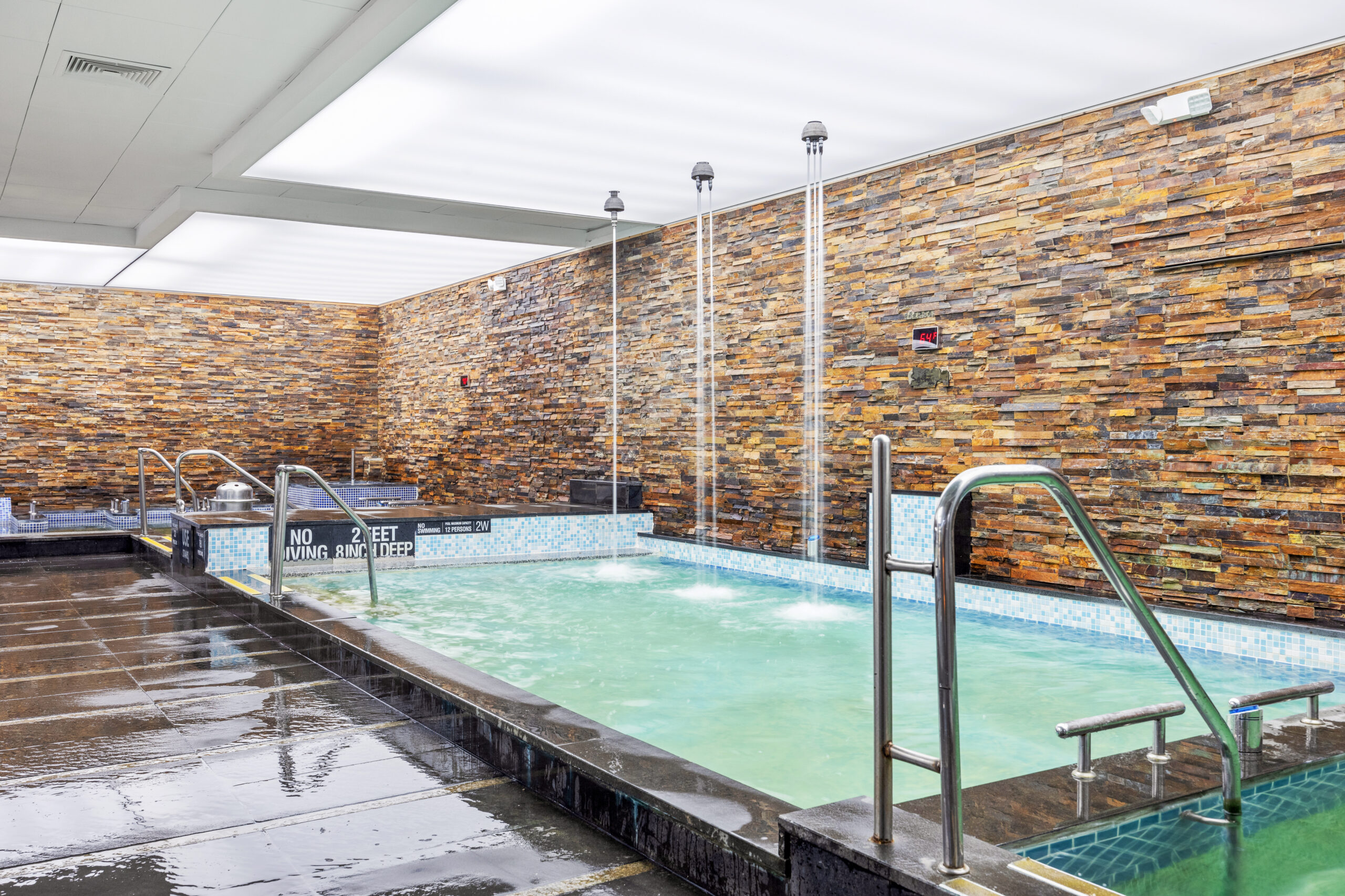 the hydrotherapy pool in the bath area, showcasing overhead pressure shower