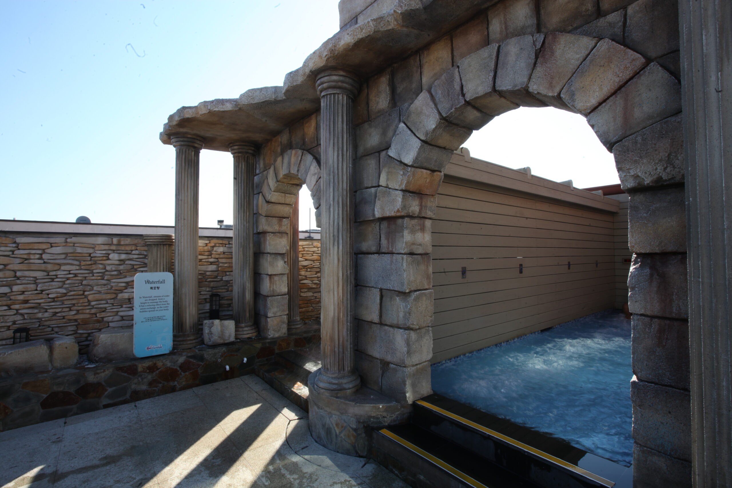 old water fall amenity located in the outdoor pool area, before renovations